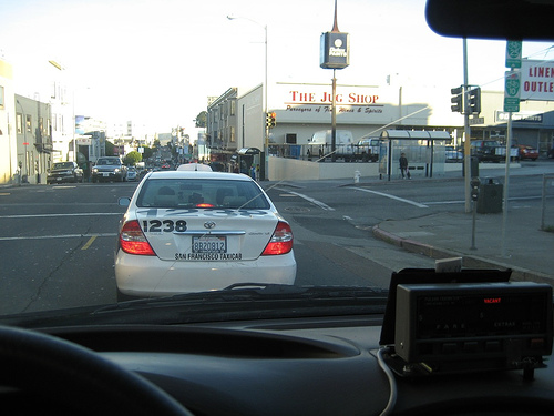 A Luxor Cab stopped at an intersection