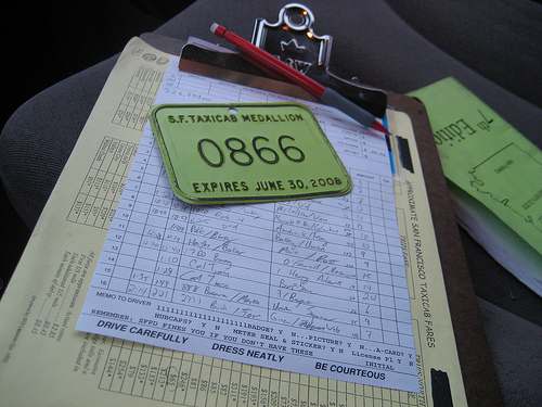 San Francisco taxi waybill and medallion on a clipboard